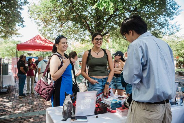 Photo: Two incoming BU students standing at a welcome table