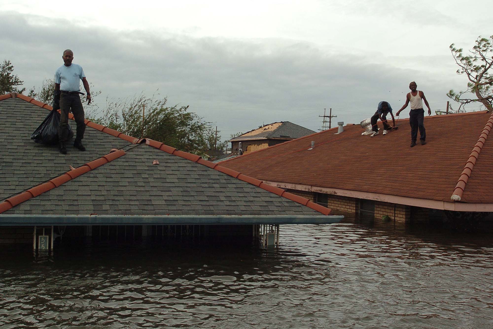 Photo: People standing on roofs during Hurricane Katrina near Bay St Louis LA