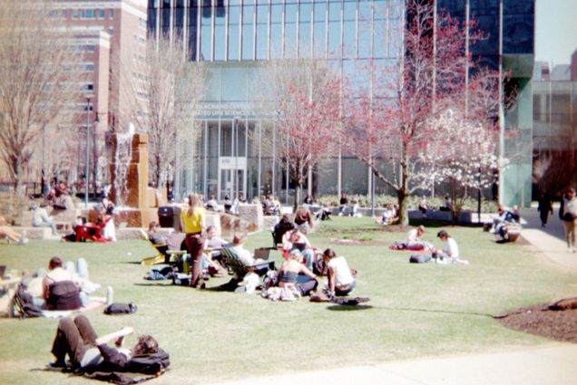 Photo: College students lounging on BU's campus green space