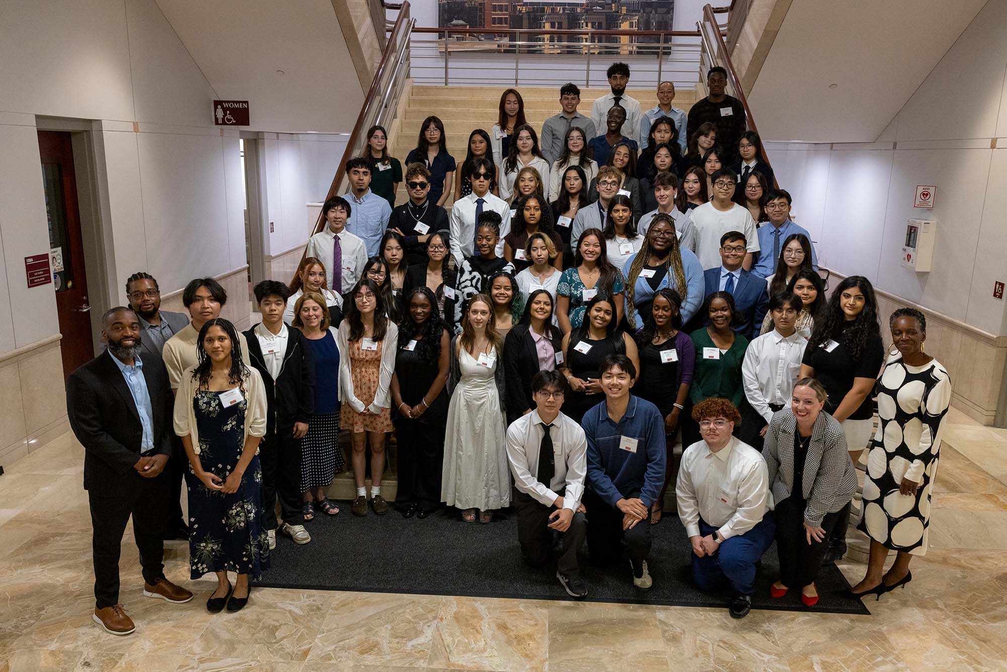 Photo: A group of Boston University Menino Scholars and Community Service Award recipients posing with BU President Melissa Gilliam
