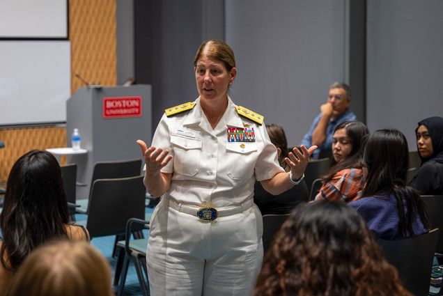 Photo: US Navy Rear Admiral Jacuelyn McClelland (MET’06) talking to a crowd of BU MET students