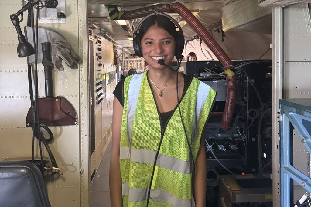 Photo: A BU student in a safety vest and headset at NASA