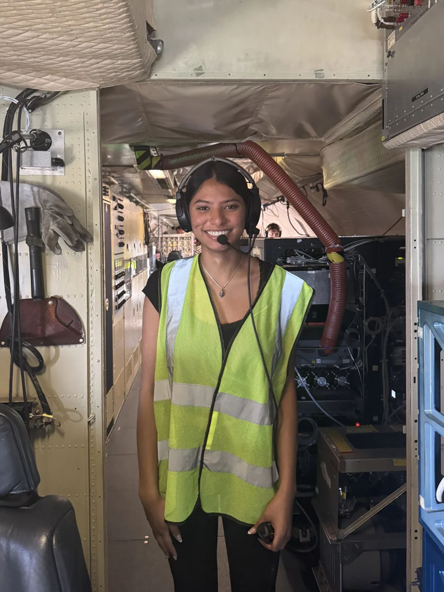Photo: A BU student in a safety vest and headset at NASA