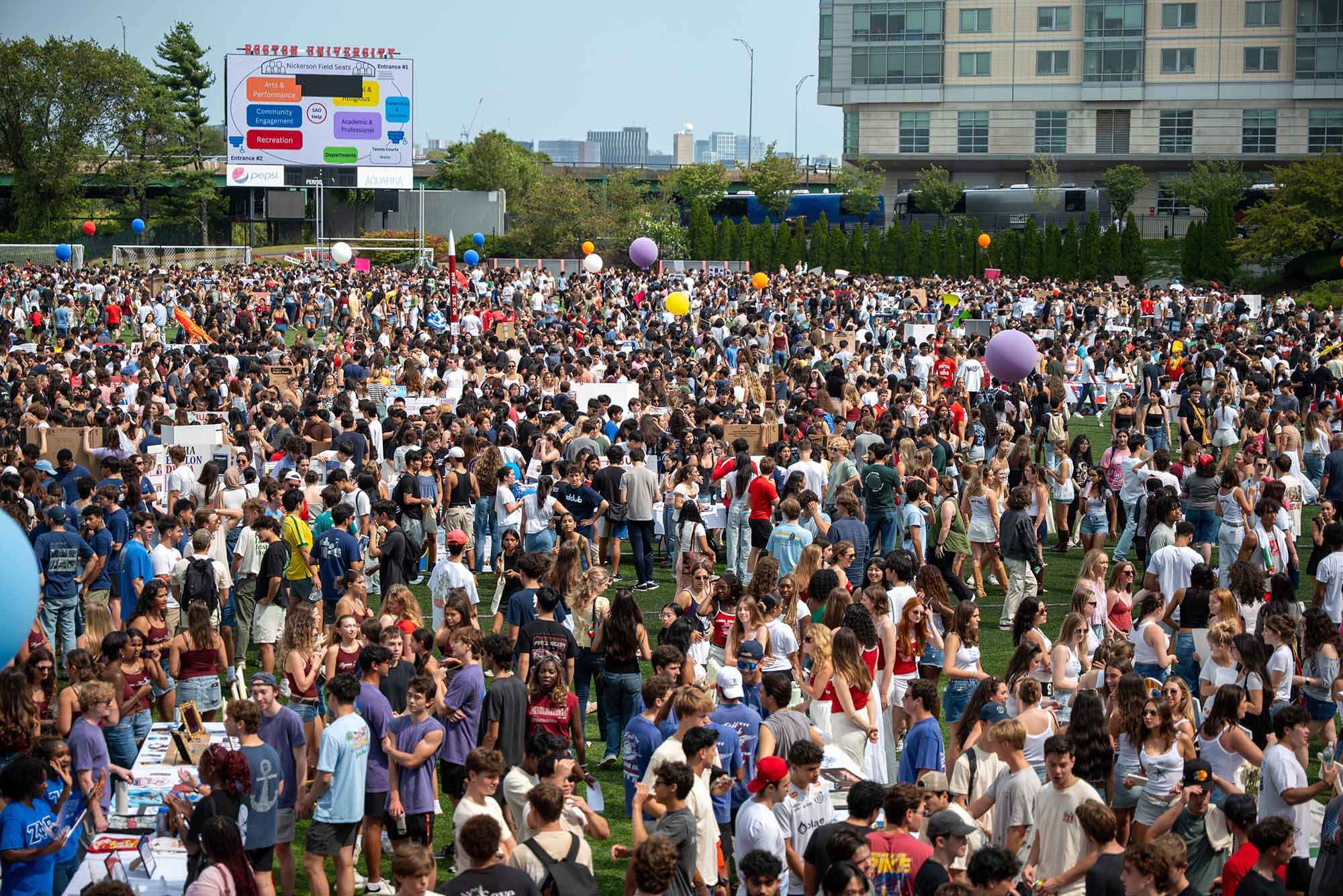 Photo: Students from all walks of BU pack Nickerson Field, exploring the wide variety of clubs advertising their organizations at BU's exciting semiannual club fair on 6 September on Nickerson Field. Photo taken by Julian Massari (ENG'26).