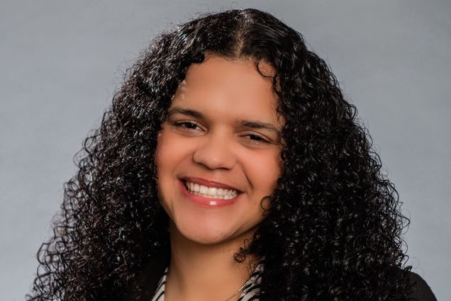 Photo: A woman poses for a formal headshot