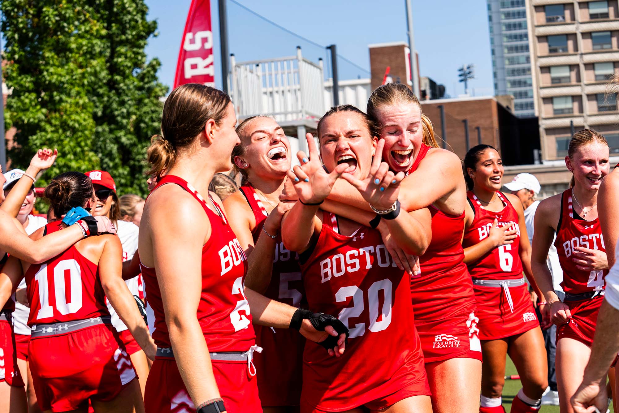 Photo: A field hockey team in red uniforms celebrating on the field