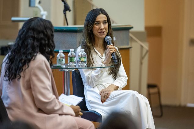 Photo: 2018 Nobel Peace Prize winner Nadia Murad on stage sitting next to her interviewer while holding a microphone