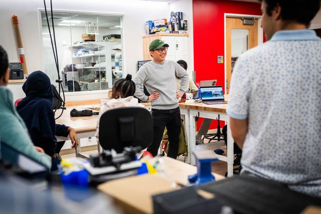 Photo: A young man enthusiastically address a class of kids at BU.