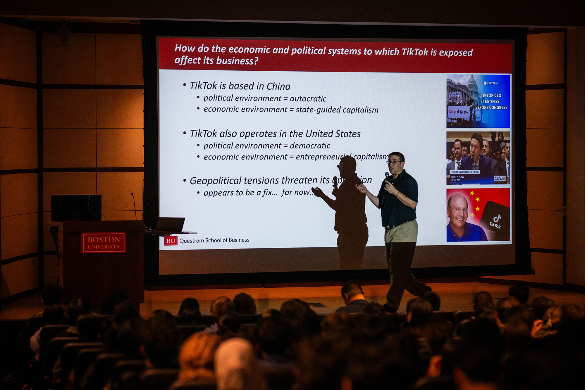 Photo: Jeffrey Furman, a Questrom School of Business professor at Boston University, standing in front of a screen that has the text "How do the economic and political systems to which TikTok is exposed affect its business?" during a class