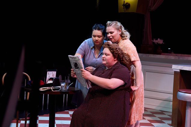 Photo: Three women in a theater production onstage in costumes