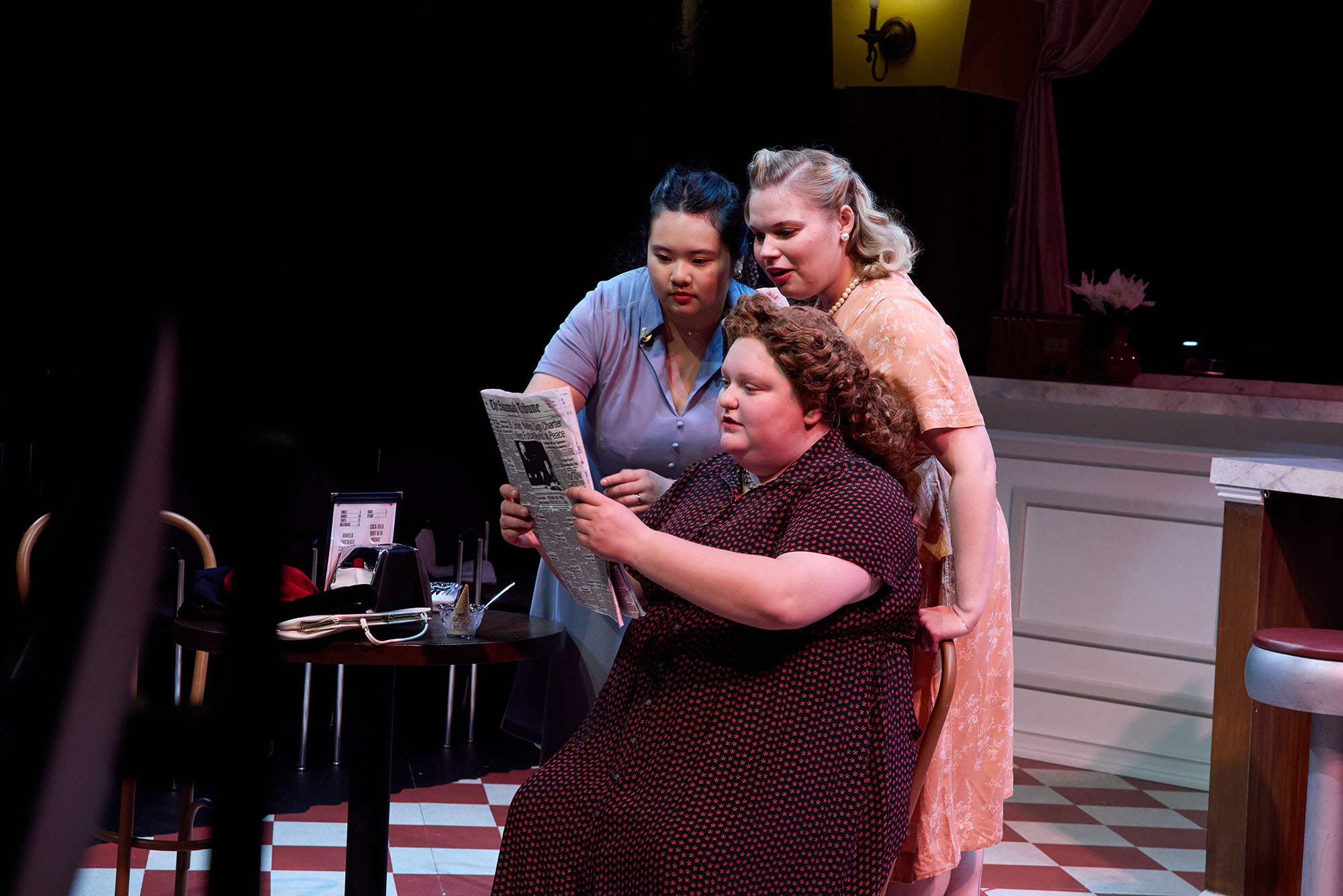 Photo: Three women in a theater production onstage in costumes
