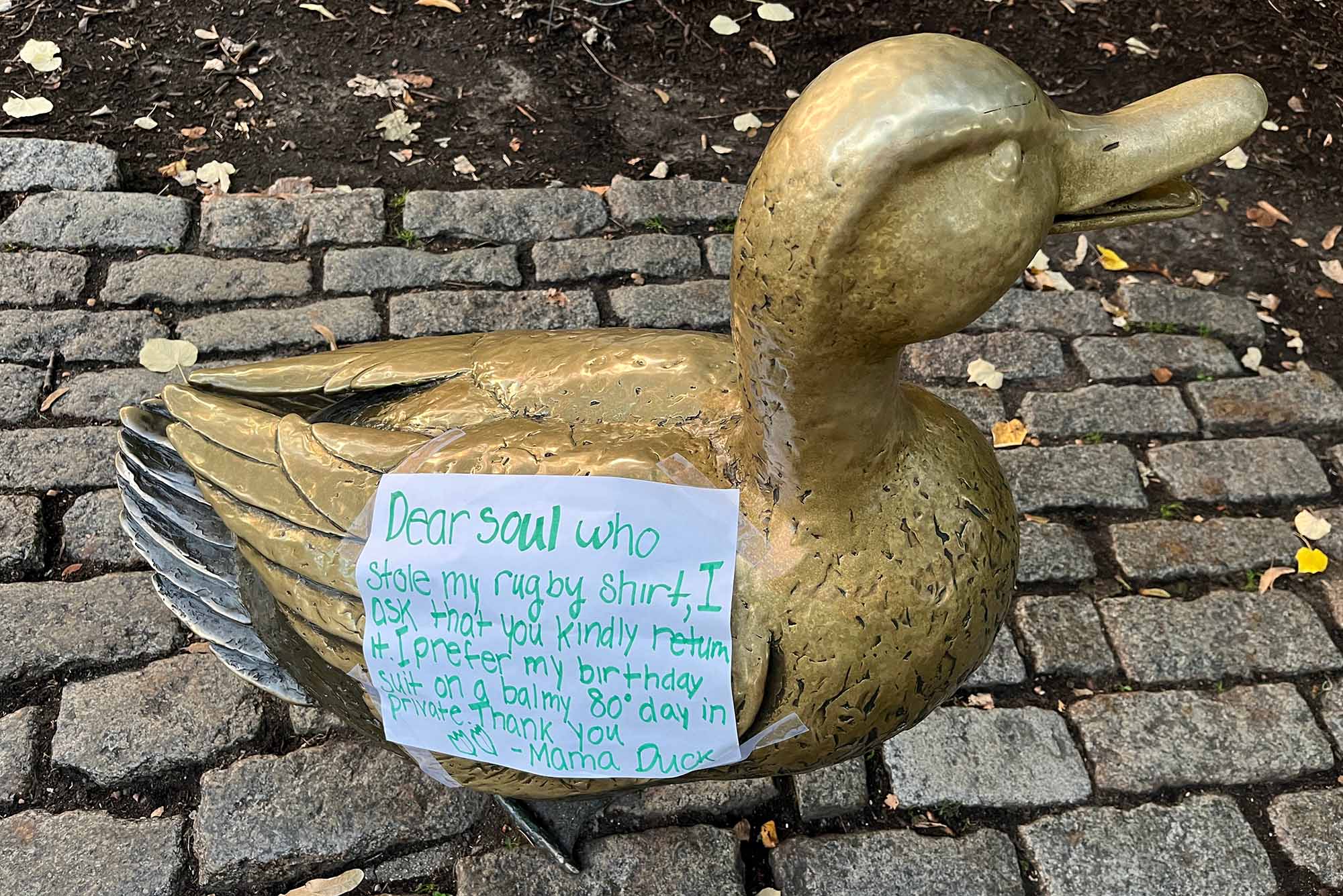 Photo: A sign on a duck statue in the "Make Way for Ducklings" sculpture at the Boston Common asking a thief to return the shirt the mama duck was wearing