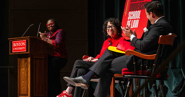 Photo: LAW Dean Angela Onwuachi-Willig, from left, applauds at a podium while Supreme Court Associate Justice Sonia Sotomayor and Cesar Lopez-Morales sit on stage at the Shapiro Lecture at Tsai Center.