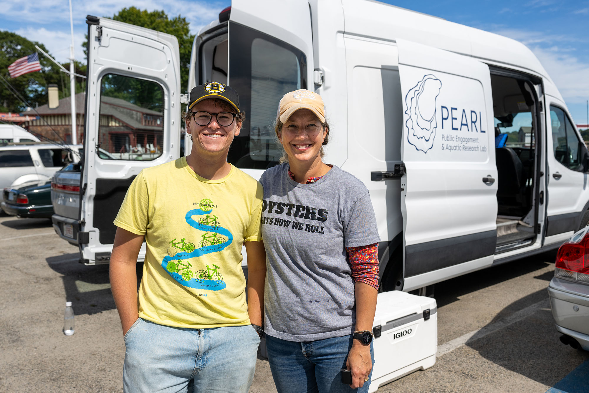 Photo: Two people smiling in front of the PEARL mobile oyster lab van