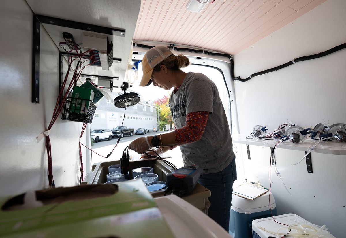 Photo: A woman working inside of the PEARL mobile oyster lab