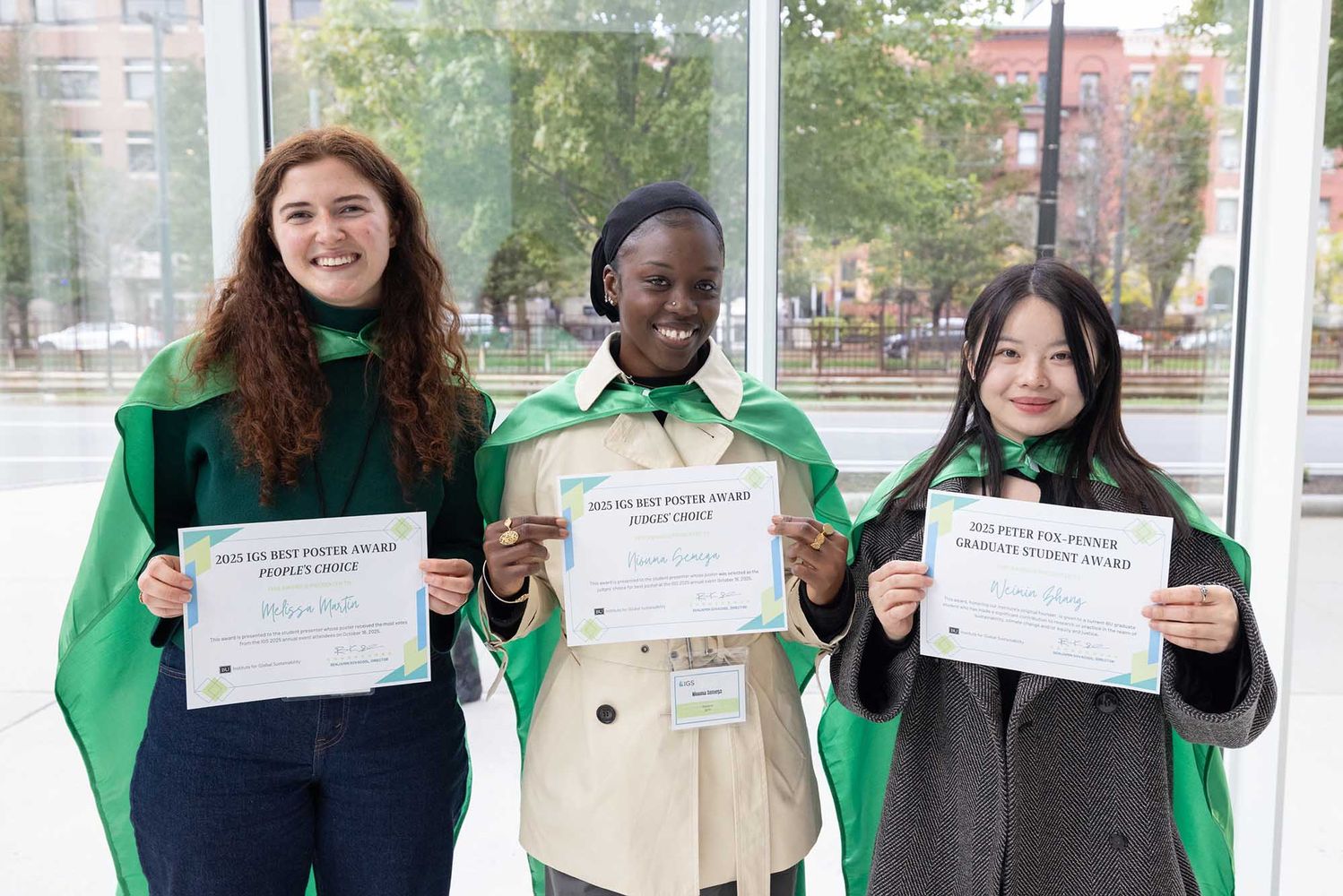 Photo: A group of three individuals pose with their certificates celebrating their student achievements