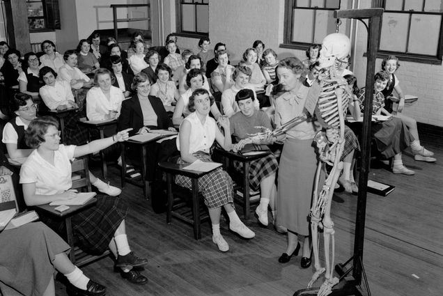 Photo: A black-and-white photo of a class with a skeleton in the front