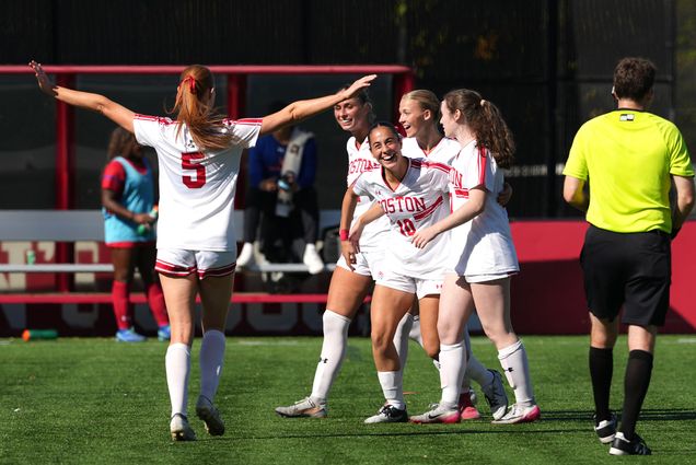 Photo: Women's soccer players embrace during a game at Boston University