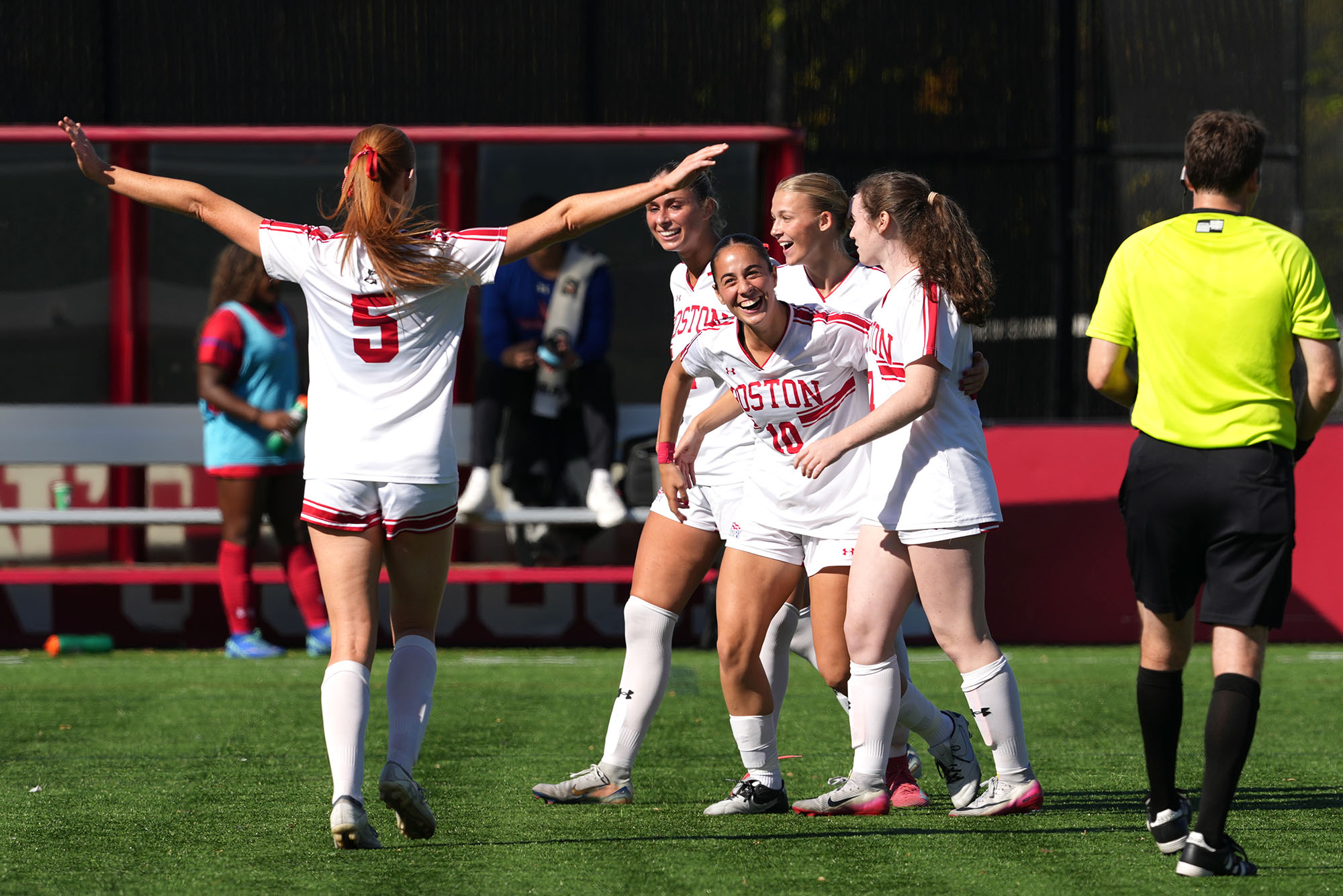 Photo: Women's soccer players embrace during a game at Boston University