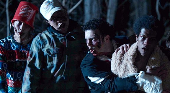 Photo: A still from a college a cappella group music video. The singers are dressed as zombies.