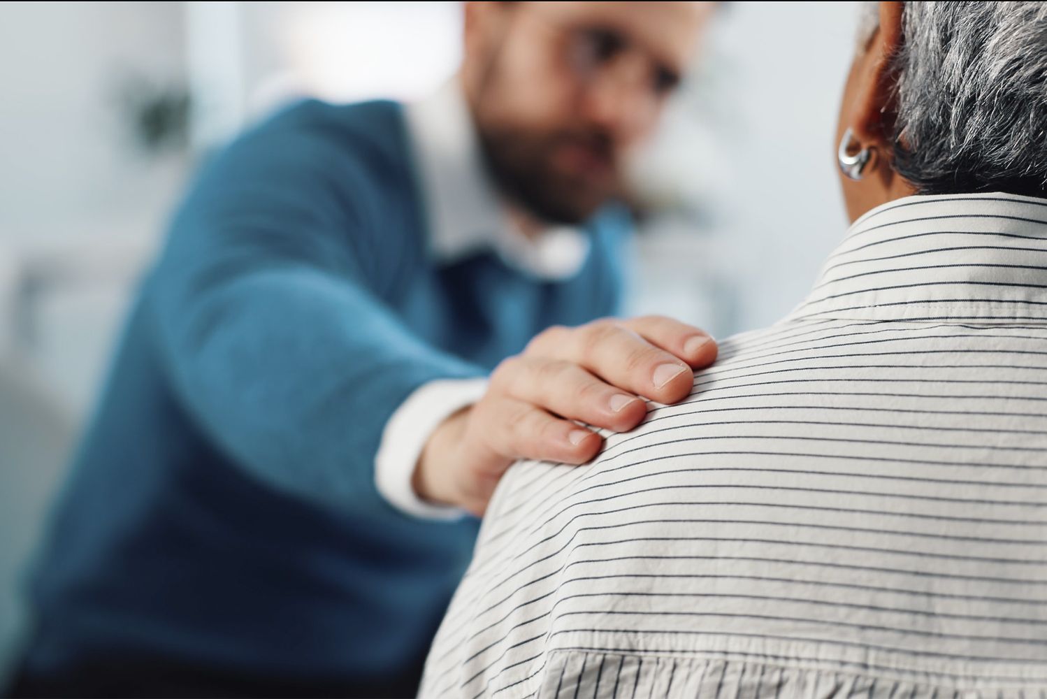 Photo: person placing their hand on another person's shoulder
