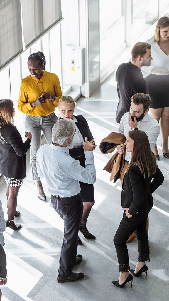 Photo: An aerial view of a room of people at a networking event