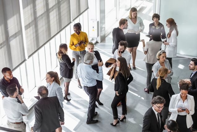 Photo: An aerial view of a room of people at a networking event
