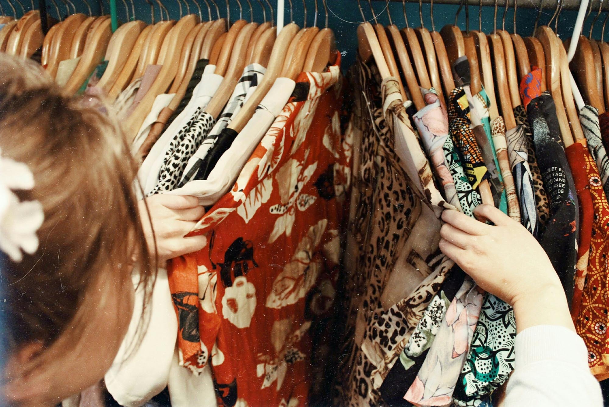 Photo: A woman looking through the racks of clothing.