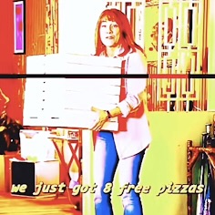 Meme: Person holding a stack of pizza boxes in a brightly colored room, with yellow text on the image reading, "we just got 8 free pizzas."