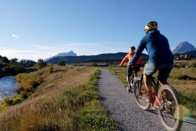 Photo: An older couple biking in nature