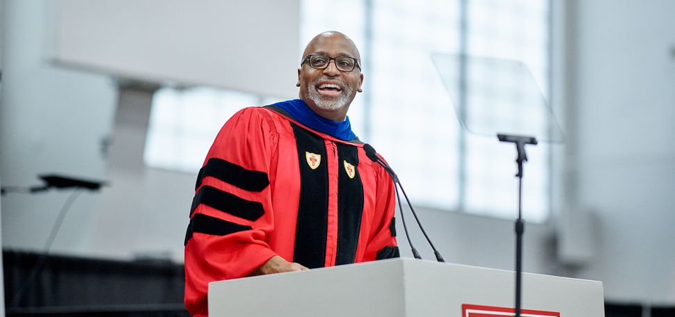 Photo: Harvey Young wearing red Boston University regalia at Commencement ceremony