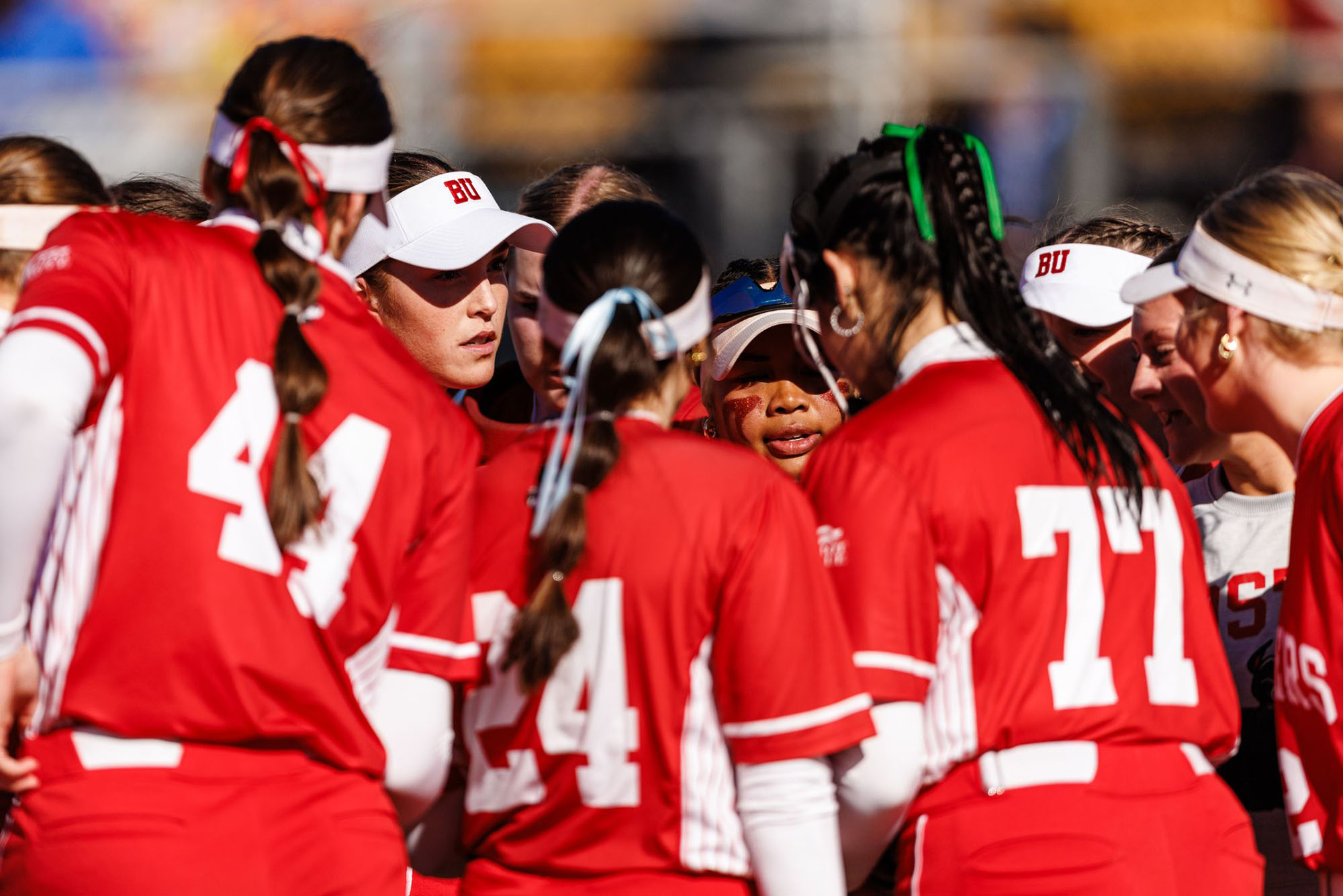 Photo: The BU softball team in a huddle against Duke at the UCF Black and Gold Invitational