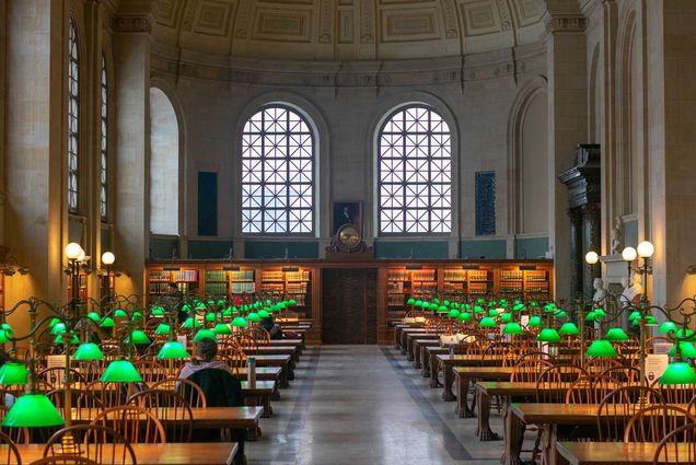 Photo: Stock of Boston Public Library with one person working at table length workspace