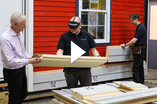 Photo: Man inspects a large piece of lumber while wearing AR glasses