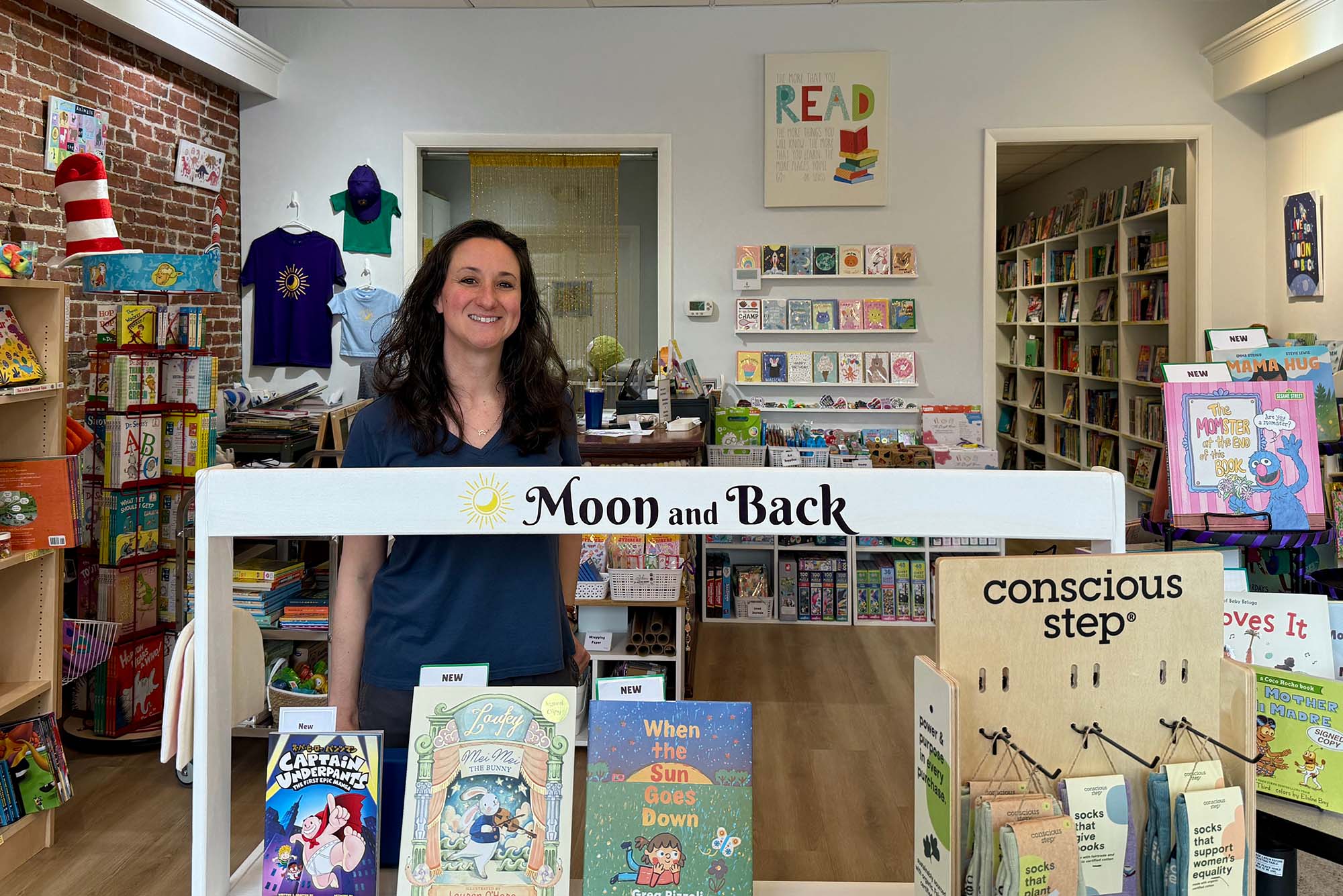 Photo: Michelle Smith posing in the interior of her Moon and Back Bookstore in West Medford, Mass