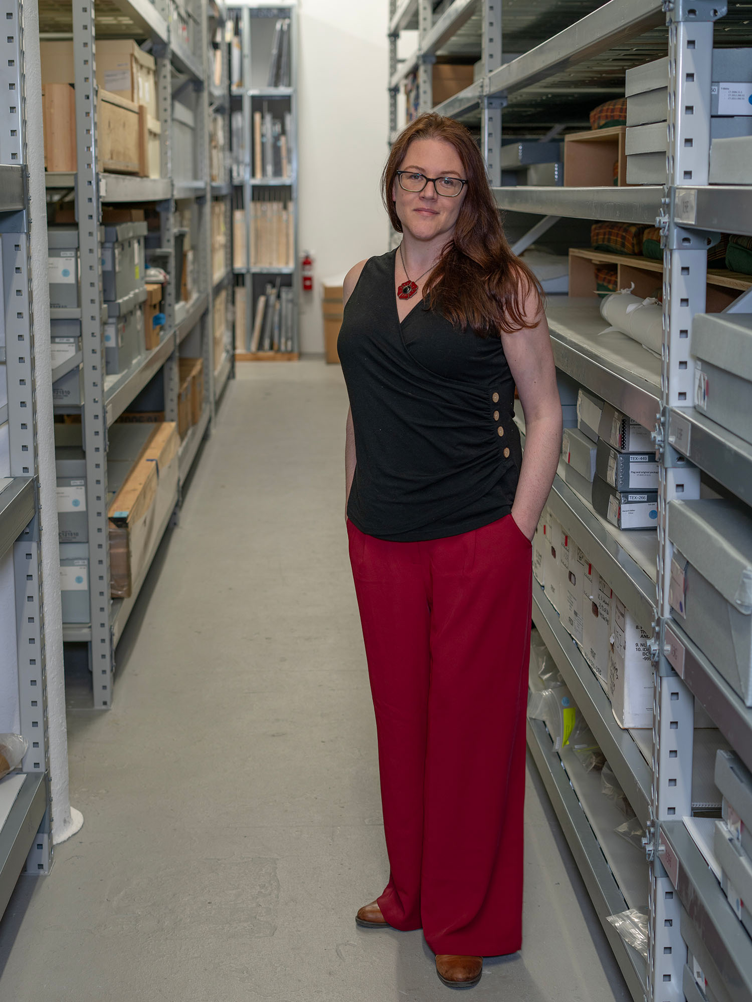 Photo: Kerith Koss Schrager, vice president and head of conservation at the 9/11 Memorial & Museum, sstanding in stacks of a collection