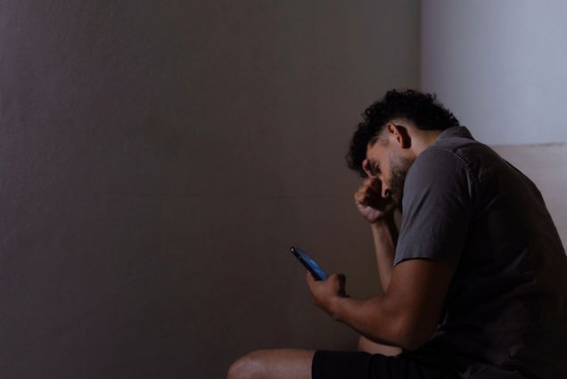 Photo: College student looks sadly at phone