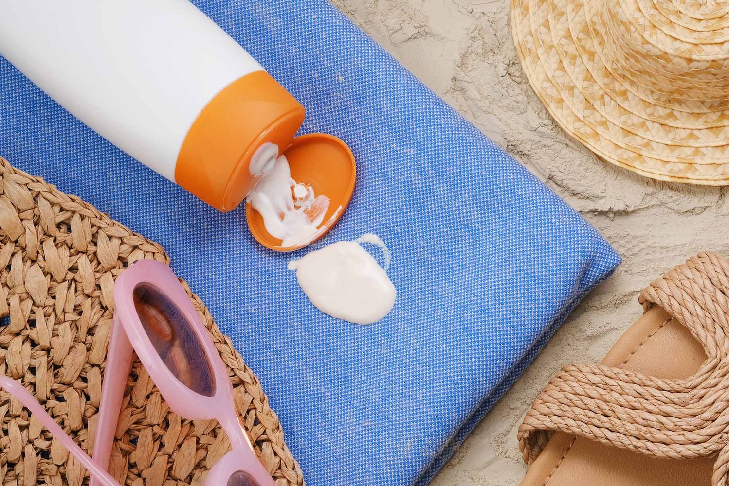 Photo: Generic stock image of a nondescript sunscreen bottle leaking onto a beach towel.