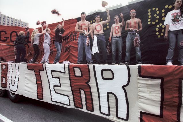 PHOTO: A retro tinted overcast day showcases a slew of BU Terrier's celebrating BU Pride on atop a parade float during homecoming 2003. Photo by Kalman Zabarsky for Boston University Photography