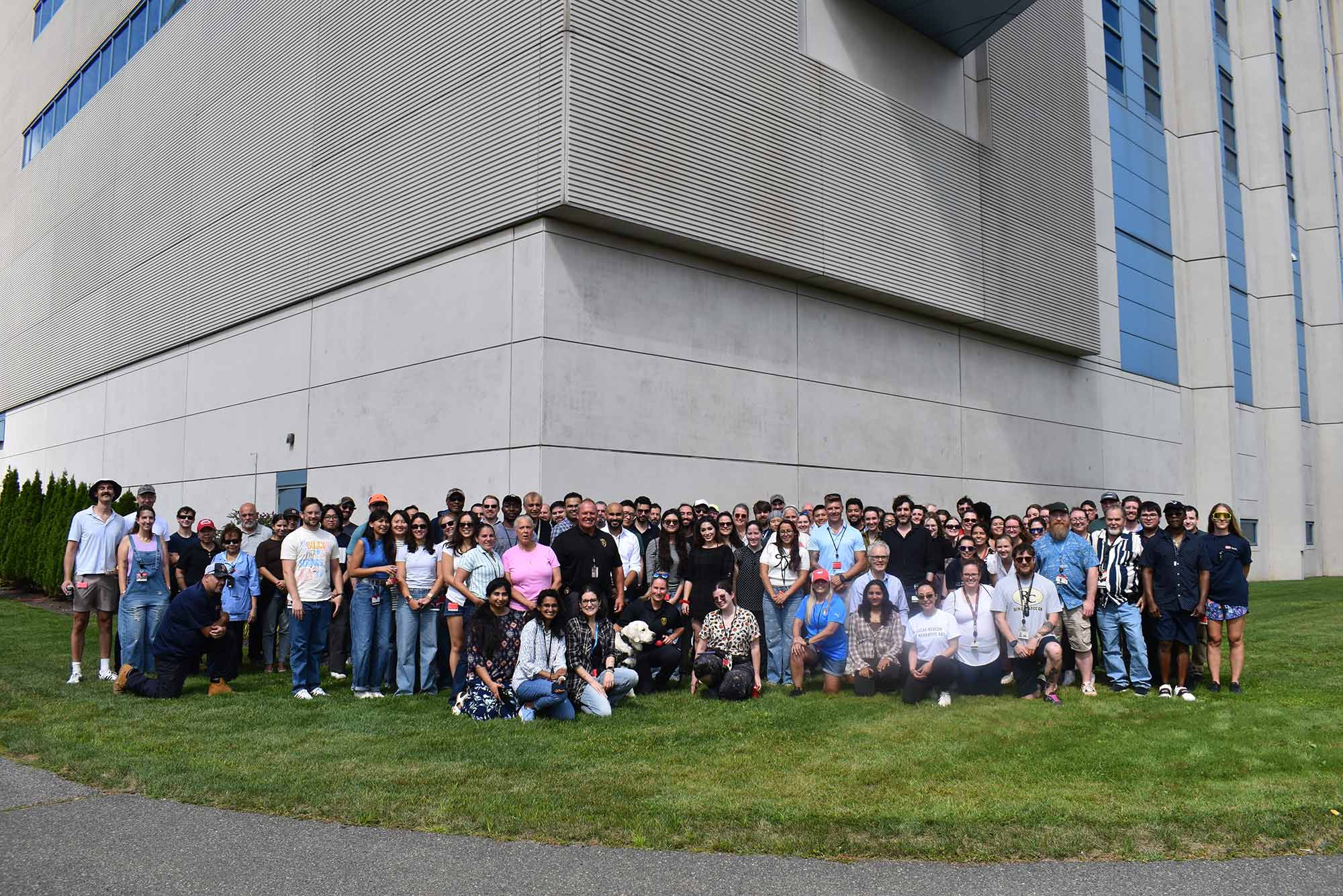 PHOTO: Faculty, staff, and students at BU’s National Emerging Infectious Diseases Laboratory (NEIDL) pose for a group photo on the NEIDL lawn, adjacent to the BU Medical Campus, during their annual field day on September 10. They are at a distance under the slightly overcast weather.