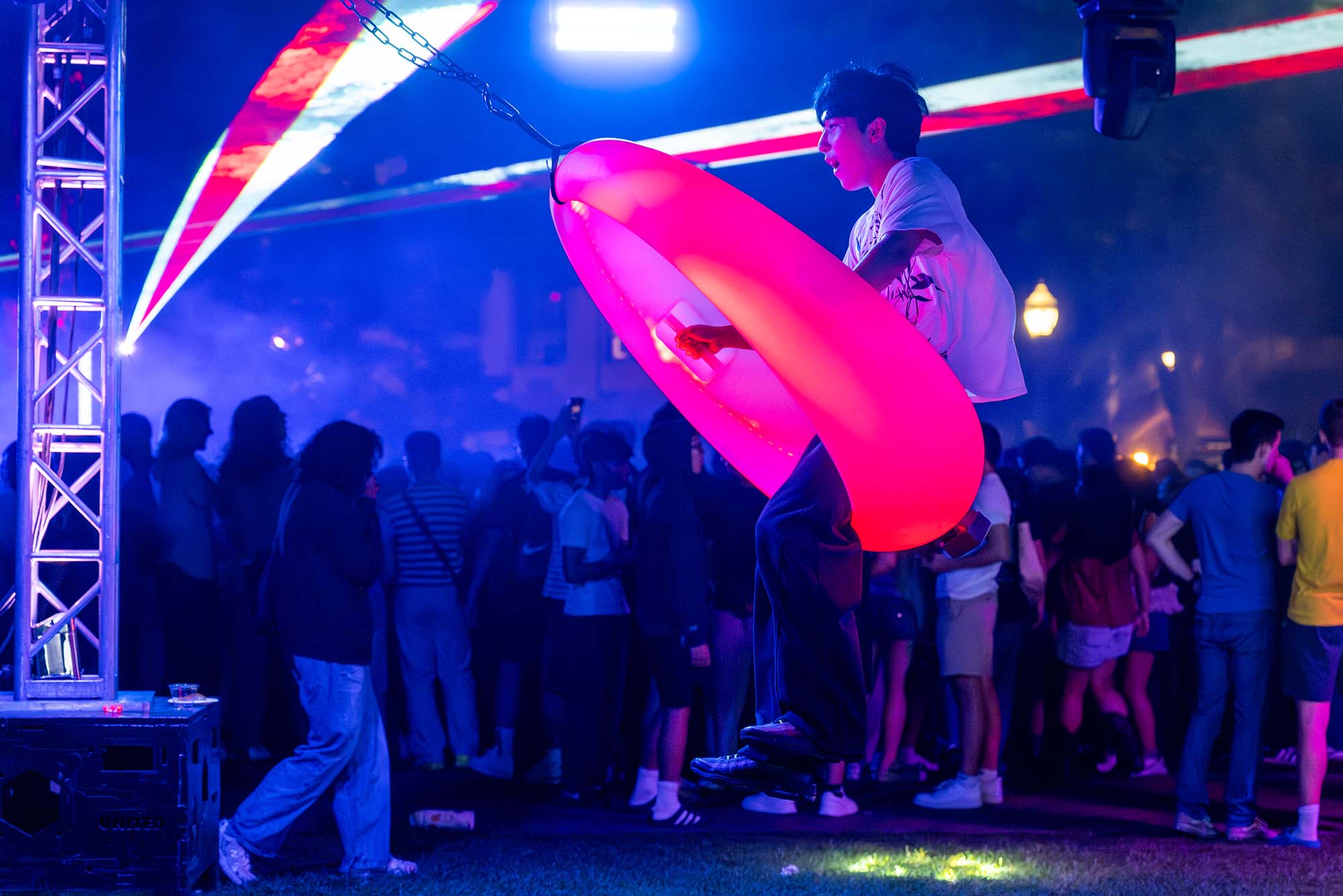Ethan Chen(CAS’28) takes a turn during BU's Student Leadership & Impact Center's 2026 Weeks of Welcome Glow Dance Party on BU Beach August 31. The event featured neon light swings, lasers, tailgate snacks, a Photo Booth and blacklight temporary tattoos. Photo by Cydney Scott