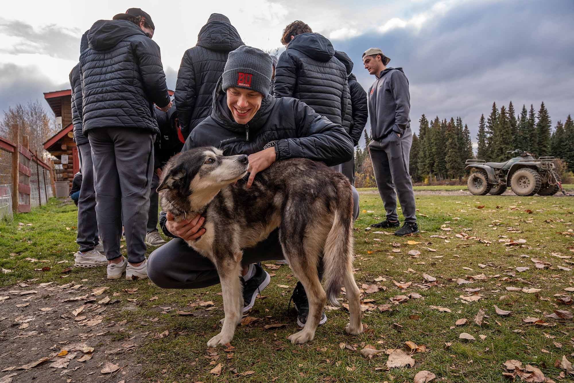 Photo: Goaltender Mikhail Yegorov (CAS'28) of the men’s ice hockey team poses with an Alaskan husky during a visit to Trail Breaker Kennel in Fairbanks, Alaska, on October 1. The Terriers opened their season with two victories over the University of Alaska, with Yegorov stopping 41 of the 42 shots he faced over the weekend. Photo by Dan Koerner