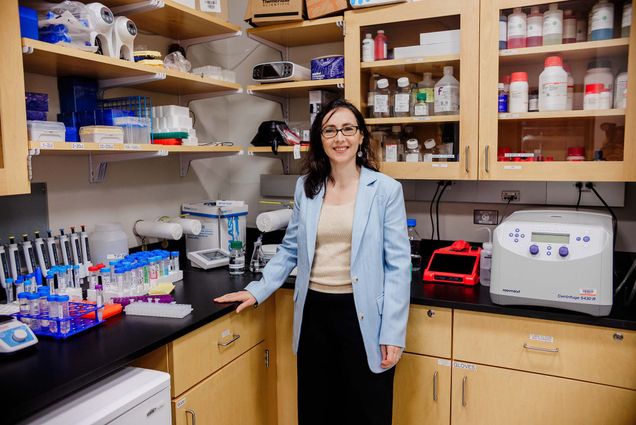 Photo: Maria (Masha) Kamenetska poses for a formal portrait surrounded by lab equipment