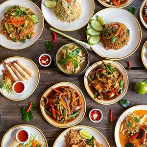 Various Thai food dishes spread across a table