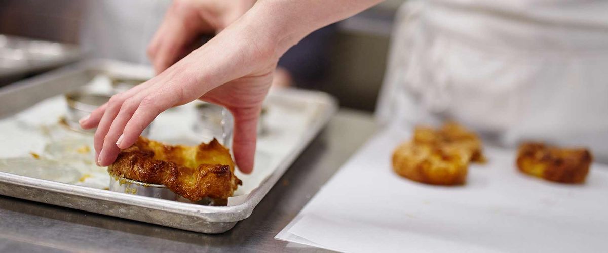 Baked goods being prepared by a chef
