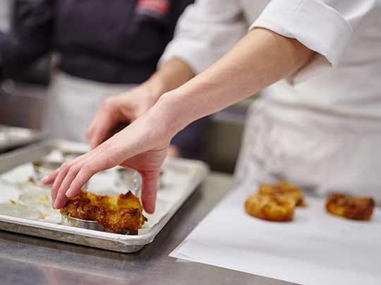 Baked goods being prepared by a chef