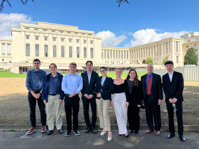 A group of 8 BU Global Governance students are photographed in front of the UN Geneva headquarters.  Also photographed is BU Prof. Mark Storella.