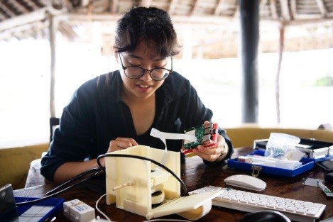 Student researcher taking images of malaria rapid diagnostics 