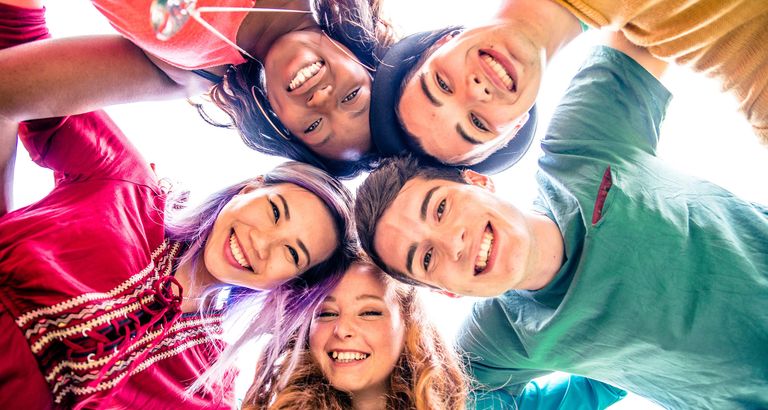 Faces of students in a circle looking down