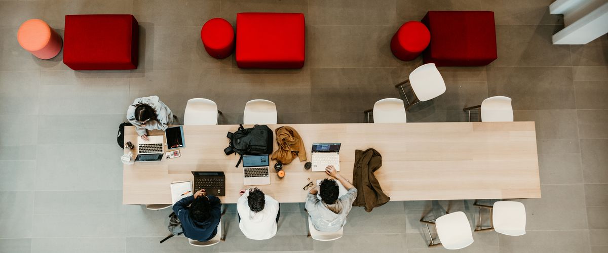 birds eye view of people working at a long table